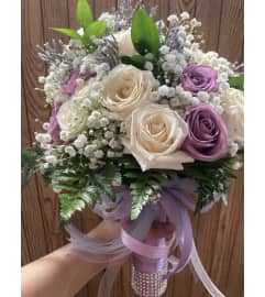 The bride is in purple. An arrangement by Floreria Mexico.