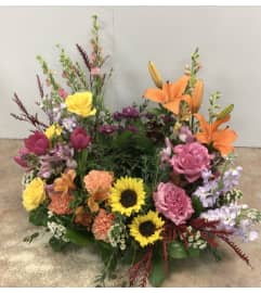 Colourful Tribute Urn Wreath. An arrangement by Roma Flowers and Gifts.