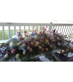 Butterfly Kiss Casket Spray. An arrangement by Now and Forever Flower Boutique.