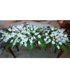 Double Lid Casket Spray. An arrangement by Now and Forever Flower Boutique.