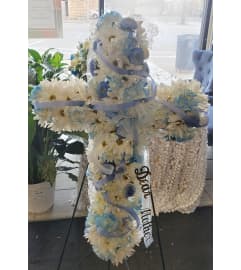Soft Blue Sympathy Cross. An arrangement by Now and Forever Flower Boutique.
