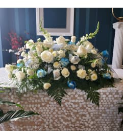 At Peace Casket Spray. An arrangement by Now and Forever Flower Boutique.