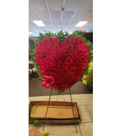 Closed Rose Heart Easel Spray. An arrangement by Now and Forever Flower Boutique.
