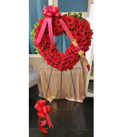 Open Heart Rose Easel Spray. An arrangement by Now and Forever Flower Boutique.