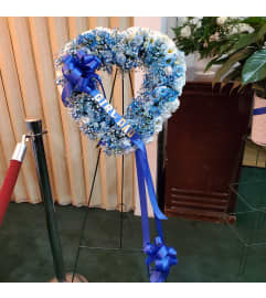 Open Heart Easel Spray. An arrangement by Now and Forever Flower Boutique.