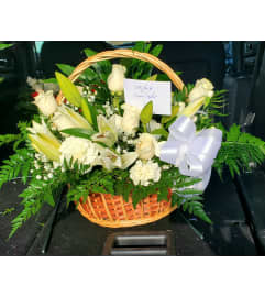 Floral White Basket. An arrangement by Now and Forever Flower Boutique.