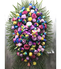 Standing Spray Rainbow. An arrangement by Elegant Florist.