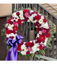 Red, white and Purple Wreath. An arrangement by Violeta's Flower Shop.