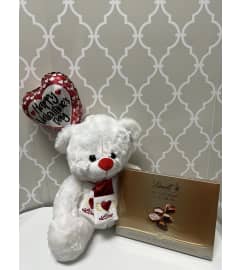 White love teddy bear. An arrangement by Shalimar Flower Shop.