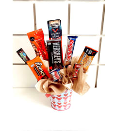 CANDY BUCKET. An arrangement by Rustic Floral and Gifts.