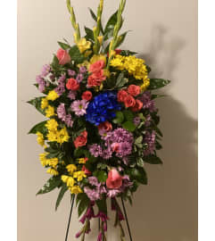 A Colorful Standing Spray. An arrangement by Seasons Change Designs.