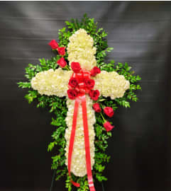 ELEGANT CROSS. An arrangement by Ditmars Flower Shop.