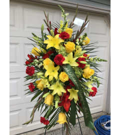 Easel Spray of Red and Yellow Flowers. An arrangement by Renton Flower Shop.