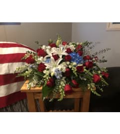 Casket Spray of Red, White, and Blue. An arrangement by Renton Flower Shop.