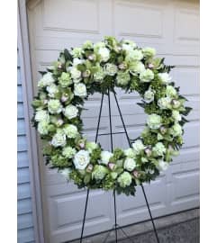 Green and White Wreath with Orchids. An arrangement by Renton Flower Shop.