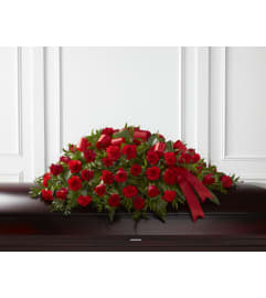 Red roses and carnations Casket Spray. An arrangement by Renton Flower Shop.