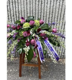 Purple Casket Spray #3. An arrangement by Seasons Change Designs.
