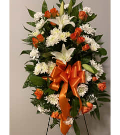 Orange Standing Spray. An arrangement by Seasons Change Designs.