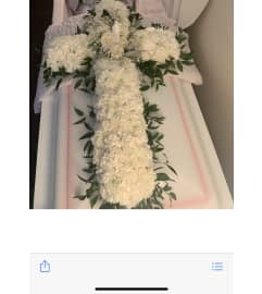 Cross on Top of Casket. An arrangement by Seasons Change Designs.
