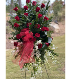 The Red rose and lily standing spray. An arrangement by Seasons Change Designs.