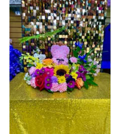 Moms Teddy. An arrangement by Manny's Flower Design.
