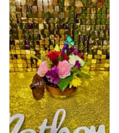 Moms Ollita. An arrangement by Manny's Flower Design.