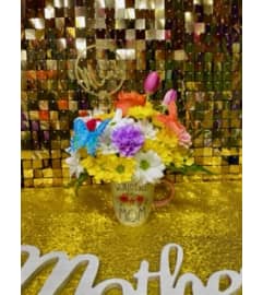 Moms Coffe Cup. An arrangement by Manny's Flower Design.
