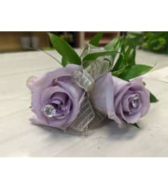 Purple Roses Corsage. An arrangement by Jennifer's Flowers and Gifts.