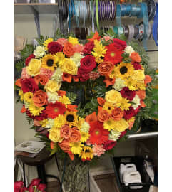 Rainbow fly heart wreath. An arrangement by Floreria Mexico.