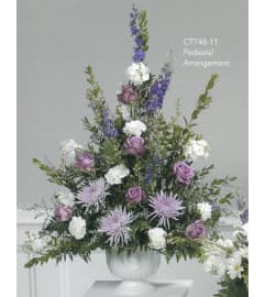 Purple and White Pedestal Arrangement( Ctt48-11). An arrangement by Roma Flowers and Gifts.