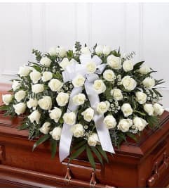 Purity in White Half Casket Cover. An arrangement by L and J Blooms.