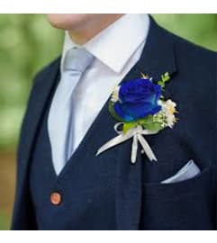 Boutonniere Royal blue. An arrangement by Geni's Florist and Gifts.