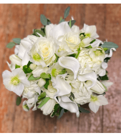 MEMORIAL SERVICE ARRANGEMENT - ASSORTED WHITE FLOWERS. An arrangement by Flowers by Priscilla.