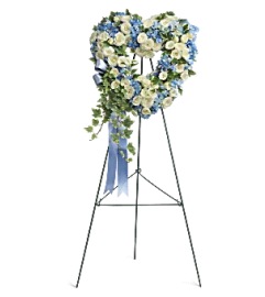 Blue and White Heart Standing Spray. An arrangement by Tallevast Florist.