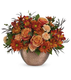 Copper Beauty Centerpiece (Teleflora). An arrangement by North Liberty Flower Shop.