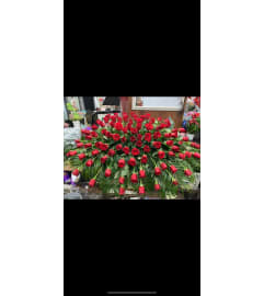 Red Rose ext. Spread Casket Spray. An arrangement by Rose Flowers.