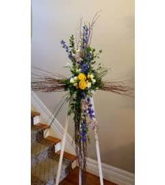 CROSS OF BIRCH BRANCHES WITH FLOWERS ADDED. An arrangement by Flowers by Priscilla.