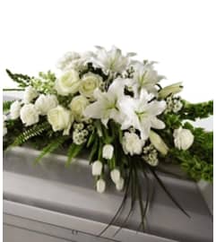 WHITE CLOUD CASKET SPRAY. An arrangement by Brasco Florist.