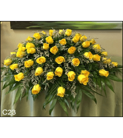 SUNSHINE CASKET SPRAY. An arrangement by Brasco Florist.