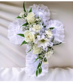 LACE CROSS PILLOW. An arrangement by Brasco Florist.