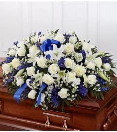 BLUE SKIES CASKET SPRAY. An arrangement by Brasco Florist.