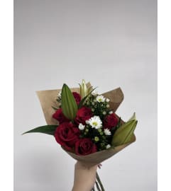 Classic Romance Hand Wrapped Bouquet. An arrangement by Mae's Flowers and Gifts.