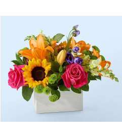 TOPAZ AND sUNFLOWERS BOX. An arrangement by Geni's Florist and Gifts.