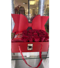 Red Purse with fresh red roses. An arrangement by Floral Lady Design Studio LLC.