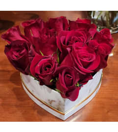 red roses in heart shape box. An arrangement by Enchanted Flowers.