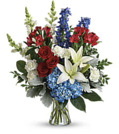 COLORFUL TRIBUTE ARRANGEMENT. An arrangement by J.D. Ballantine's Flowers and Gifts.