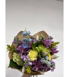 Fresh Spring Mixed Wrapped Bouquet. An arrangement by Mae's Flowers and Gifts.