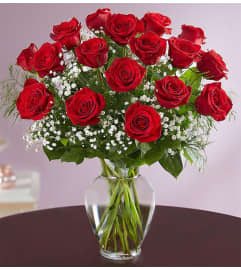 18 RED ROSES VASED. An arrangement by Howard Beach Florist.