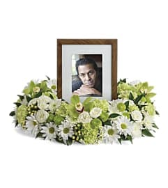 GARDEN WREATH TRIBUTE. An arrangement by J.D. Ballantine's Flowers and Gifts.