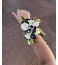 Blue and White Corsage. An arrangement by Rose Flowers.